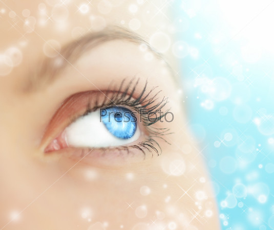 Human eye on blue background, stock photo