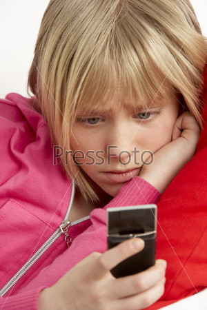 Young Girl Reading Text And Looking Worried