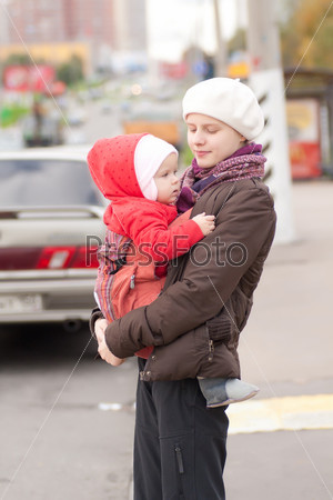 Mother and toddler girl stay on crossroad