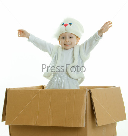 The boy in a suit of a rabbit jumps out of a box with the lifted hands