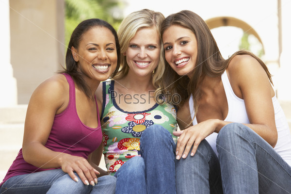 Three Girlfriends Sitting On Steps Of Building