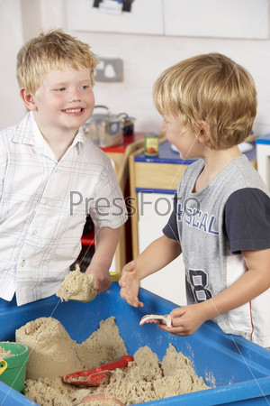 Two Young Boys Playing Together in Sandpit