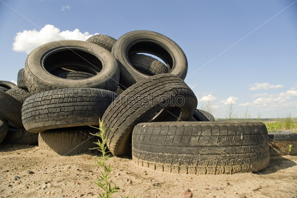 A lot of Wheel Tires dumped in a landfill.