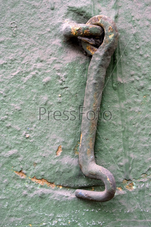 Old wall with a metal hook.