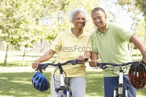 Senior Couple Riding Bikes In Park