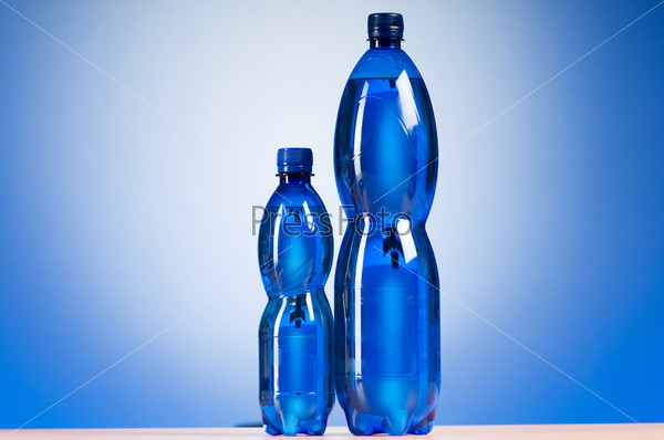 Bottle of water against colorful gradient background, stock photo