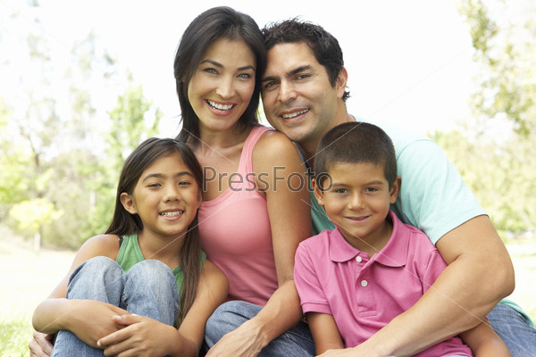 Portrait Of Young Family In Park