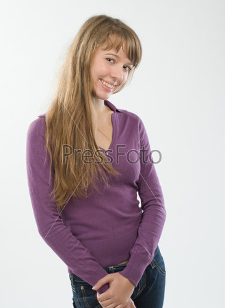 Beautiful young woman at studio over plain background