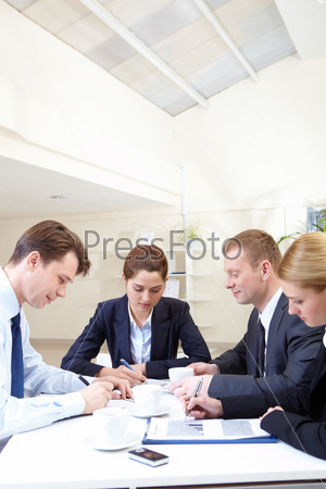 Image of several companions working with papers at meeting