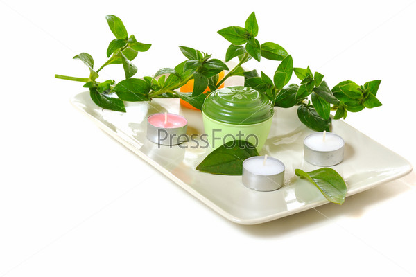 scented candles  and green leaves  on white background