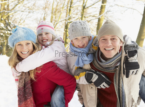 Family Having Fun Snowy Woodland