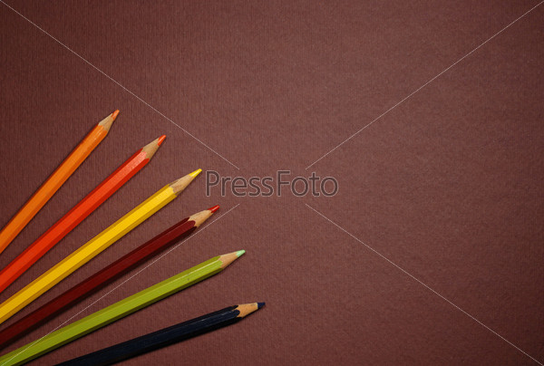 Empty brown cardboard background and coloured pencils - art utensil