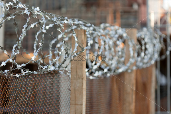 Security protection sharp metal barbed wire fence, stock photo