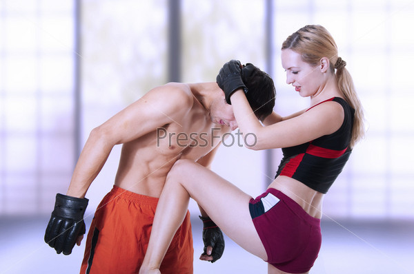 Fight. Woman fighter knee kick in mans stomach