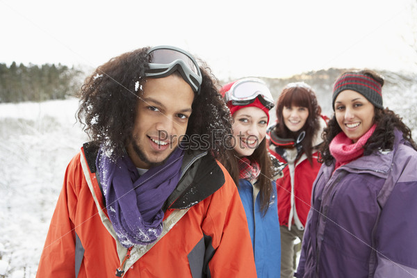 Group Of Teenage Friends Having Fun In Snowy Landscape Wearing Ski Clothing, stock photo