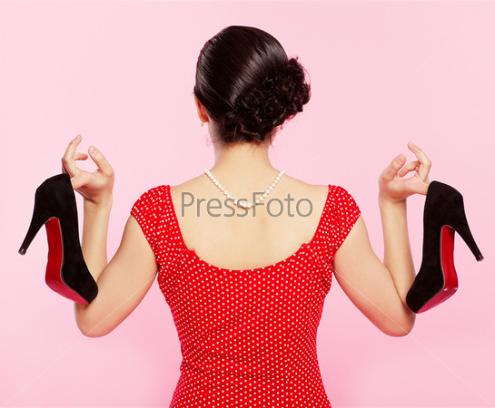 pin-up style portrait of brunette girl standing back to the observer