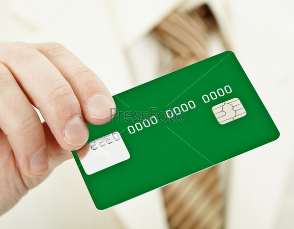 The person holds a green electronic plastic card in a hand