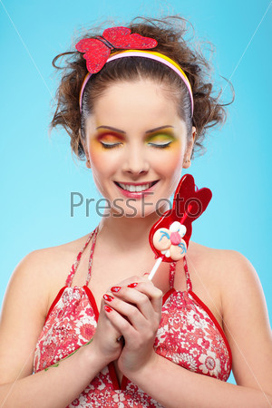 portrait of beautiful slavonic girl posing with red bunny-lollipop