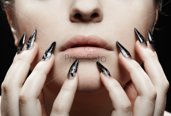 close-up portrait of girl\'s lower part of face and manicured fingers