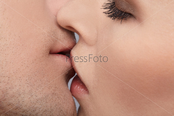 close up portrait of young caucasian couple kissing