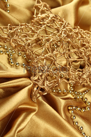 On gold fabric are gold ornaments and Christmas Gold Star. Background
