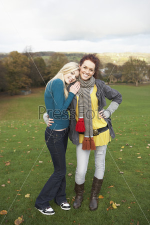 Group Of Two Teenage Female Friends In Autumn Landscape