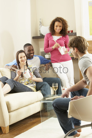 Group Of Friends Enjoying Chinese Takeaway Meal At Home