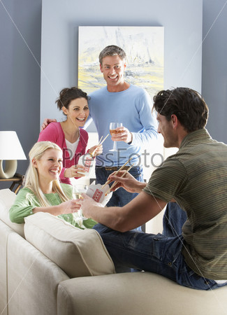 Group Of Friends Enjoying Chinese Takeaway Meal At Home, stock photo