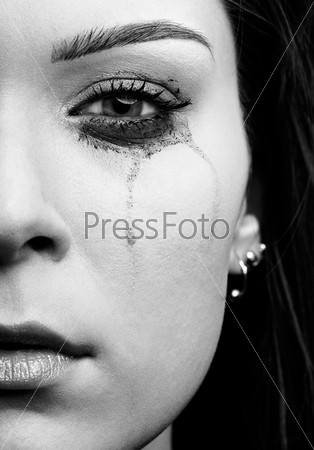 close-up portrait of beautiful crying girl with smeared mascara