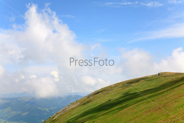 stones on summer mountain slope and beautiful cloudy landscape (Ukraine, Carpathian Mountains)