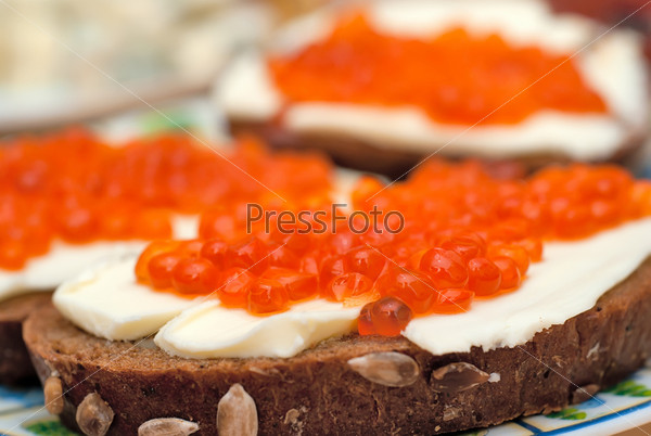 sandwich with red caviar, butter and rye bread