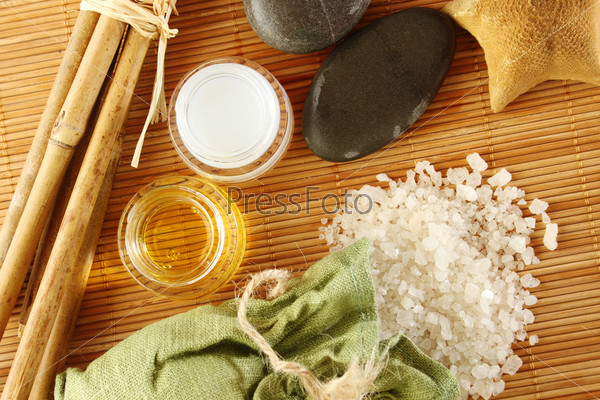 Facilities for body care in a fabric bag of bath salts, related to bamboo sticks, starfish, stones, and two jars of cream and oils