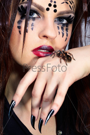 portrait of girl with spider Brachypelma smithi bodyart of face zone