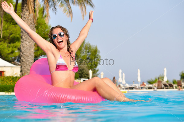 Very happy woman on pink air bed