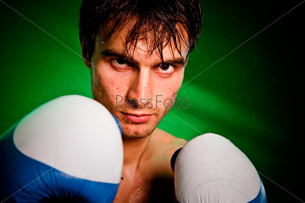 Man sweating all over in boxing gloves...