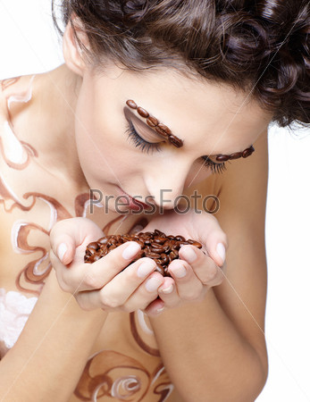 Girl with coffee theme body-art and coffee beans in hands