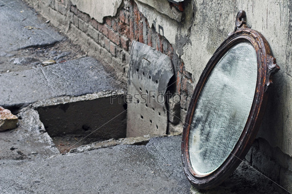Thrown Out Old Mirror Standing Against Wall, stock photo