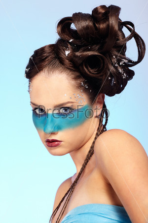 portrait of beautiful girl with blue stripe facial bodyart and fantasy hair-do with several thin braids