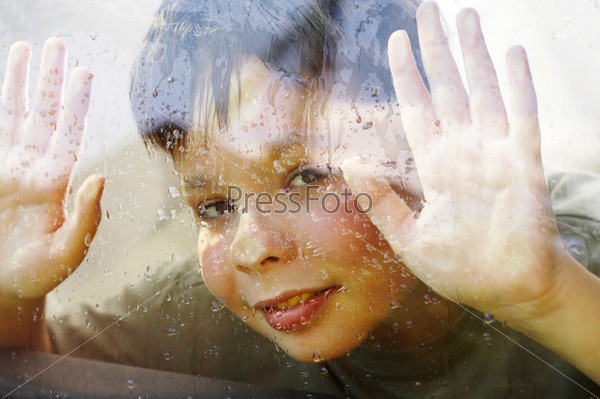 child and window on a wet rainy day ...