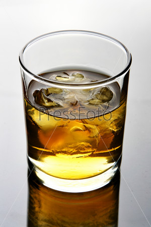 Glass of whiskey with ice close up
