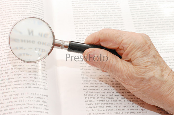 Image of magnifier in old hand