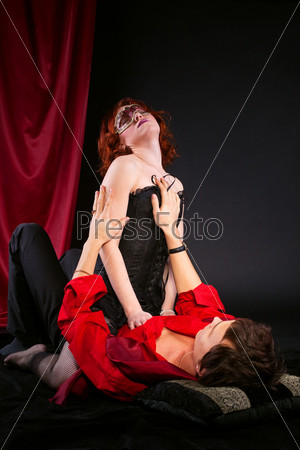 Red woman in mask on man - love scene