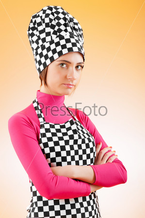Young female cook against gradient background