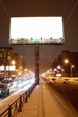 Big white empty billboard on the night street