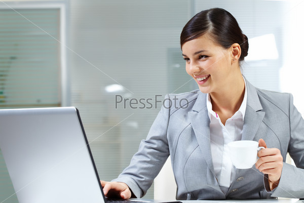 Image of young employer doing computer work in office, stock photo