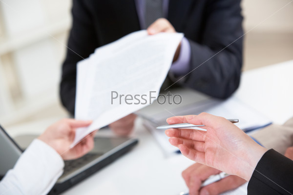 Close-up of human hand with pen pointing at document , stock photo