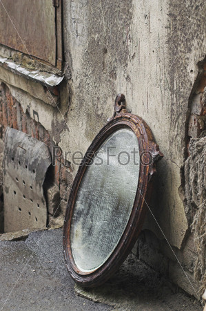 Thrown Out Old Mirror Standing Against Wall