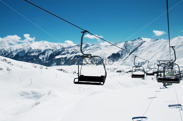 Ski lift chairs on bright winter day, stock photo