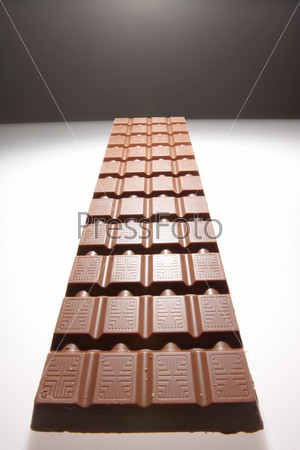 Big chocolate is photographed in kind of road leaving in night, beyond the horizon