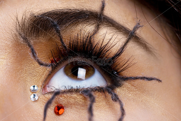 woman eye close-up with spider make up